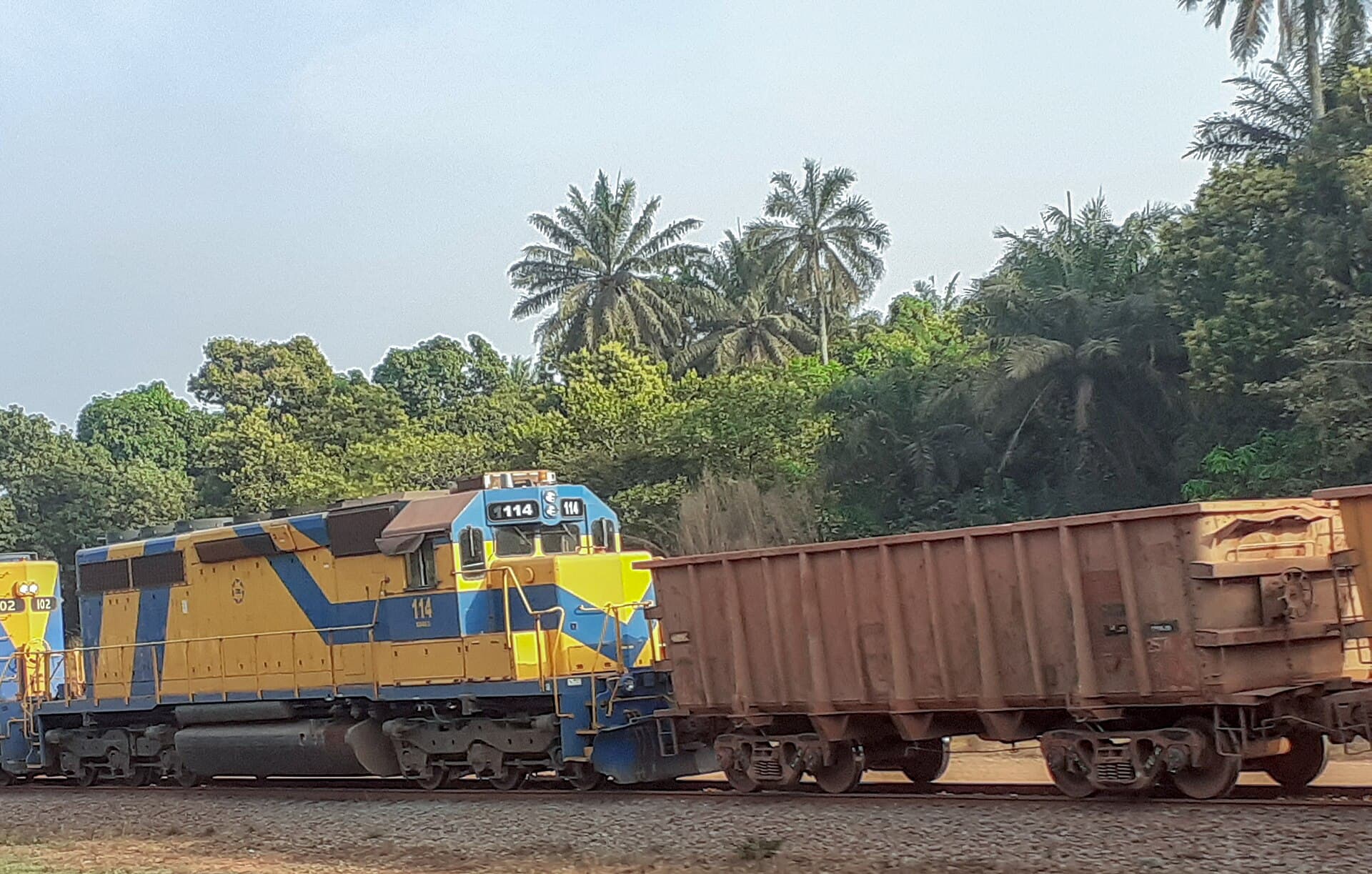 Locomotive and ore wagons on the Sangarédi–Kamsar line, Guinea